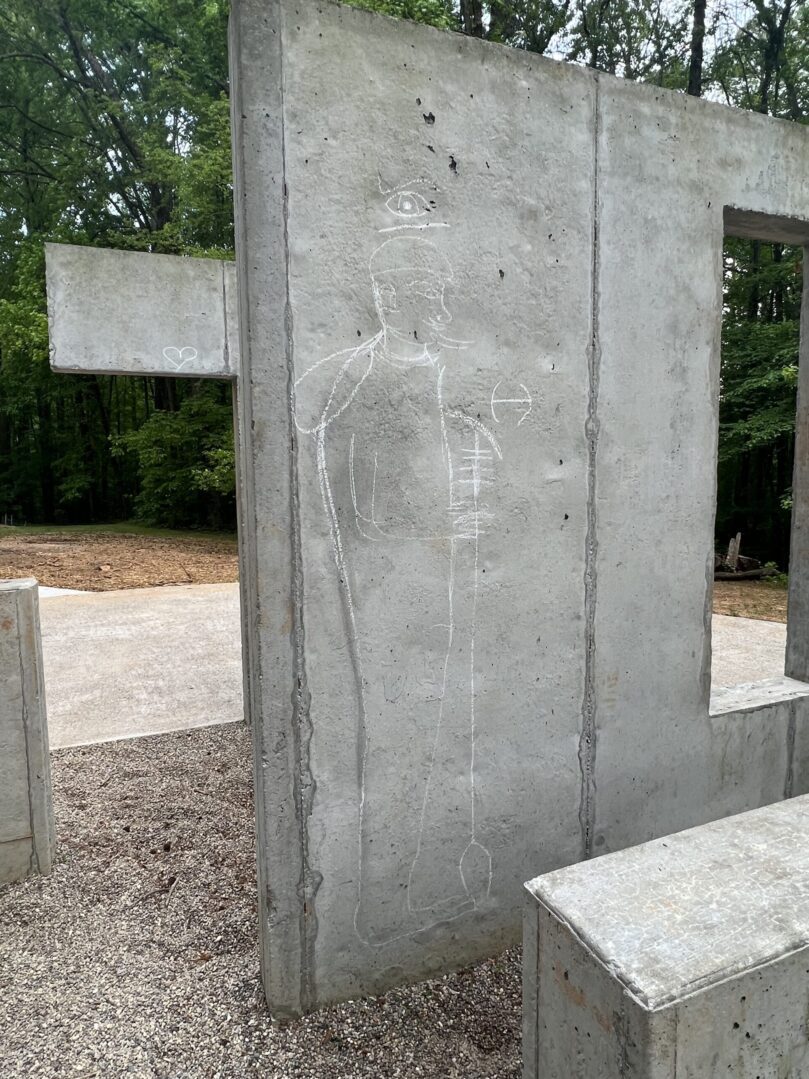 A concrete wall with some writing on it