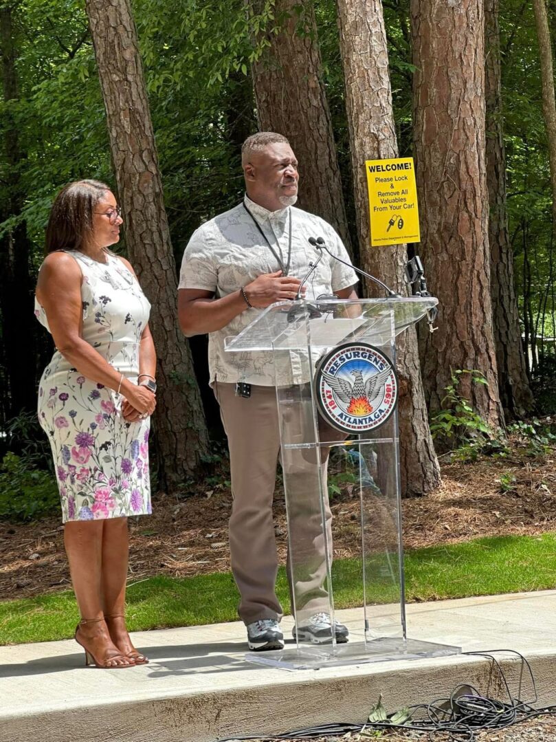 A man and woman standing in front of a podium.