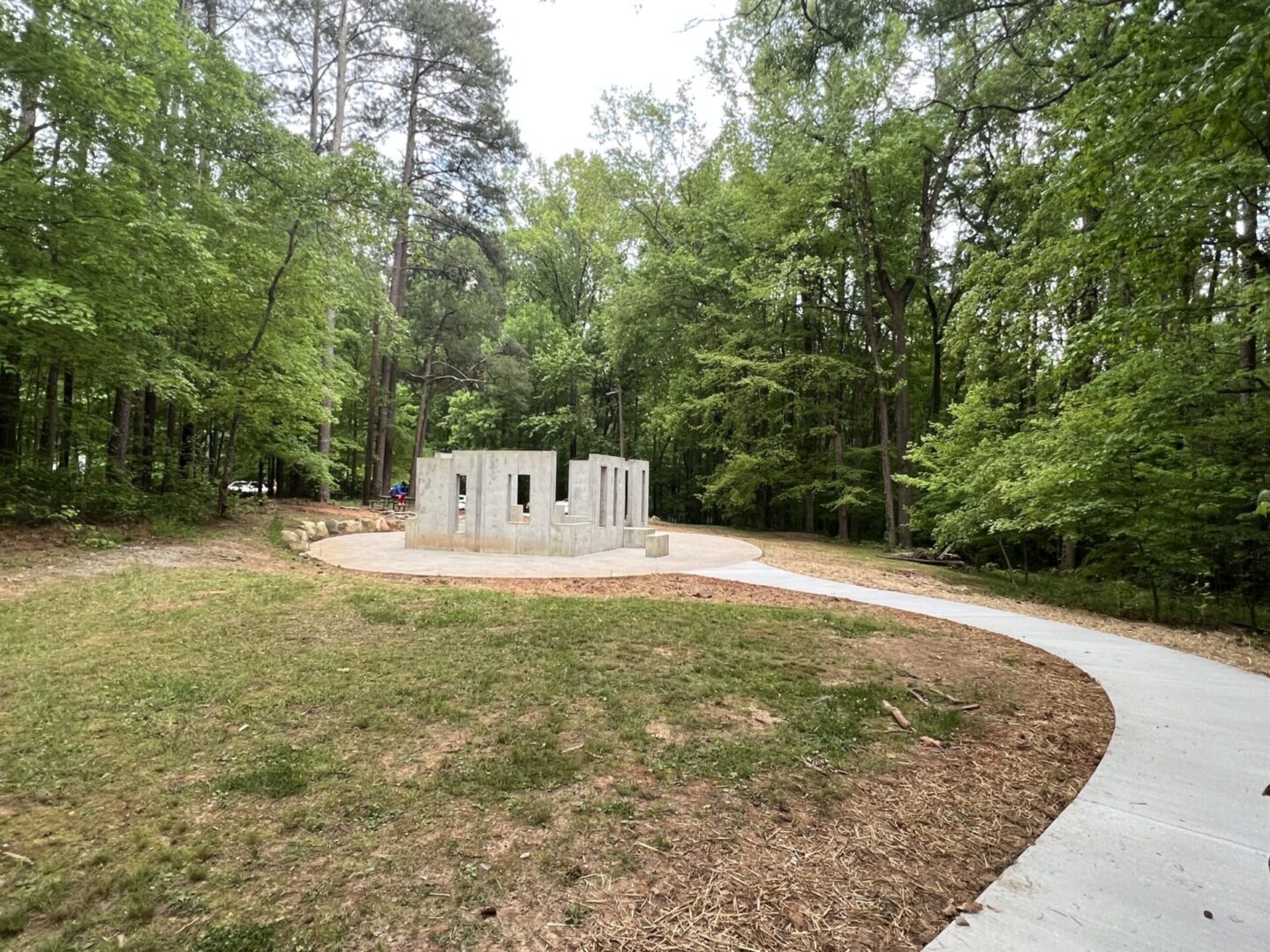 A park with trees and grass in the background