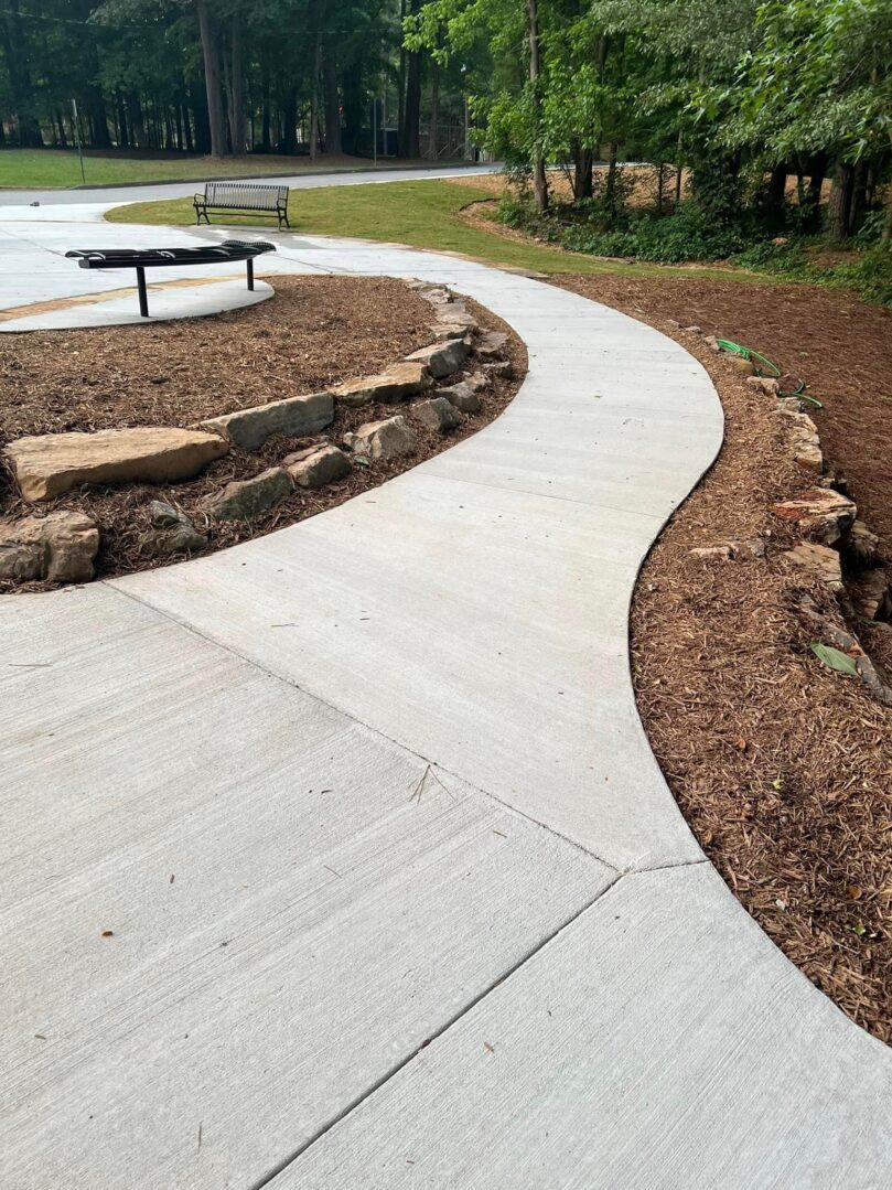 A walkway with rocks and grass in the middle of it.