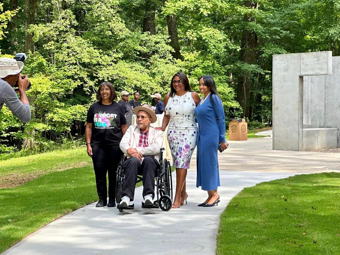 A man in a wheelchair with three women.