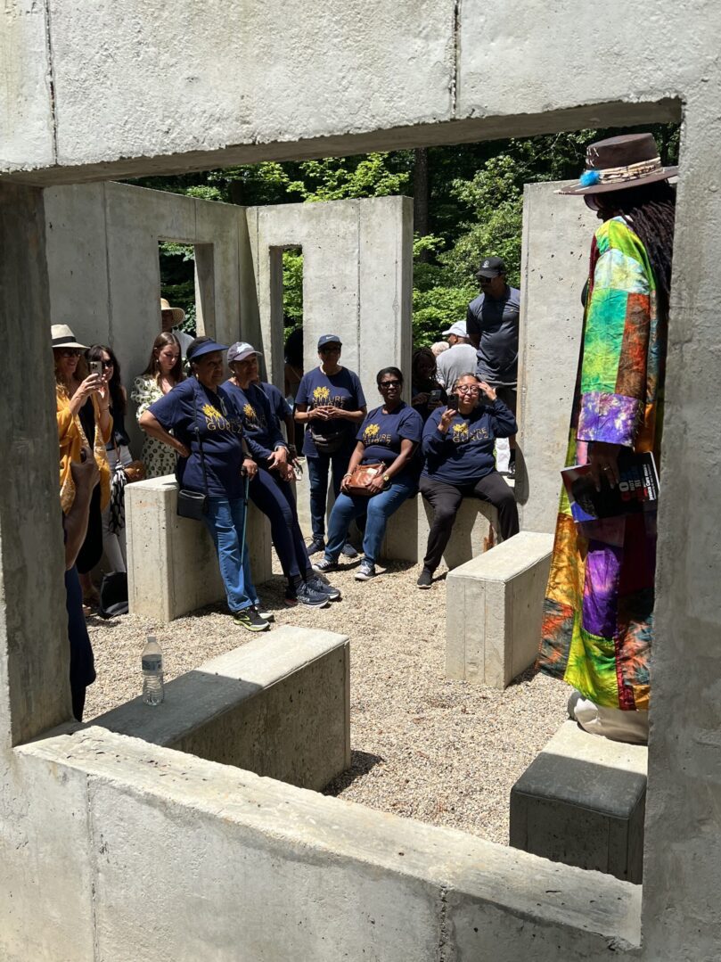 A group of people sitting around in concrete blocks.