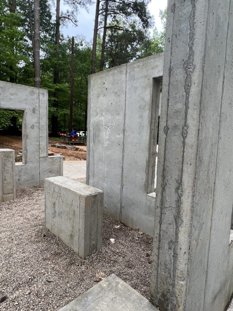 A concrete wall with some trees in the background