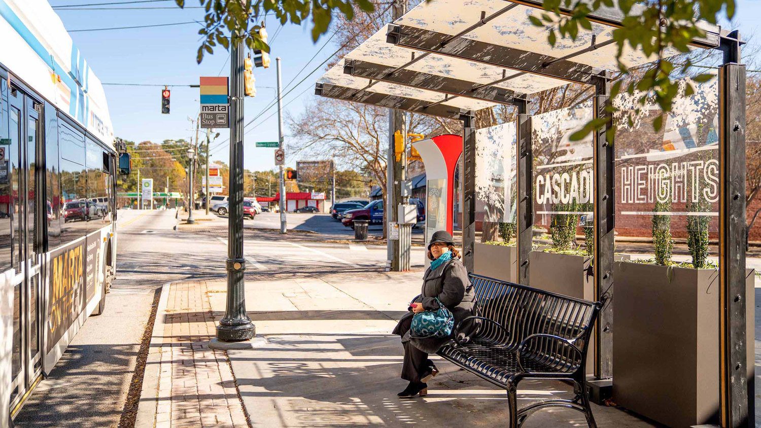 A person sitting on top of a bench.